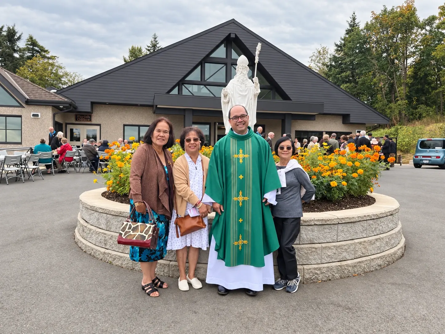 Father Mel and parishioners gathered outside the church during a community barbecue