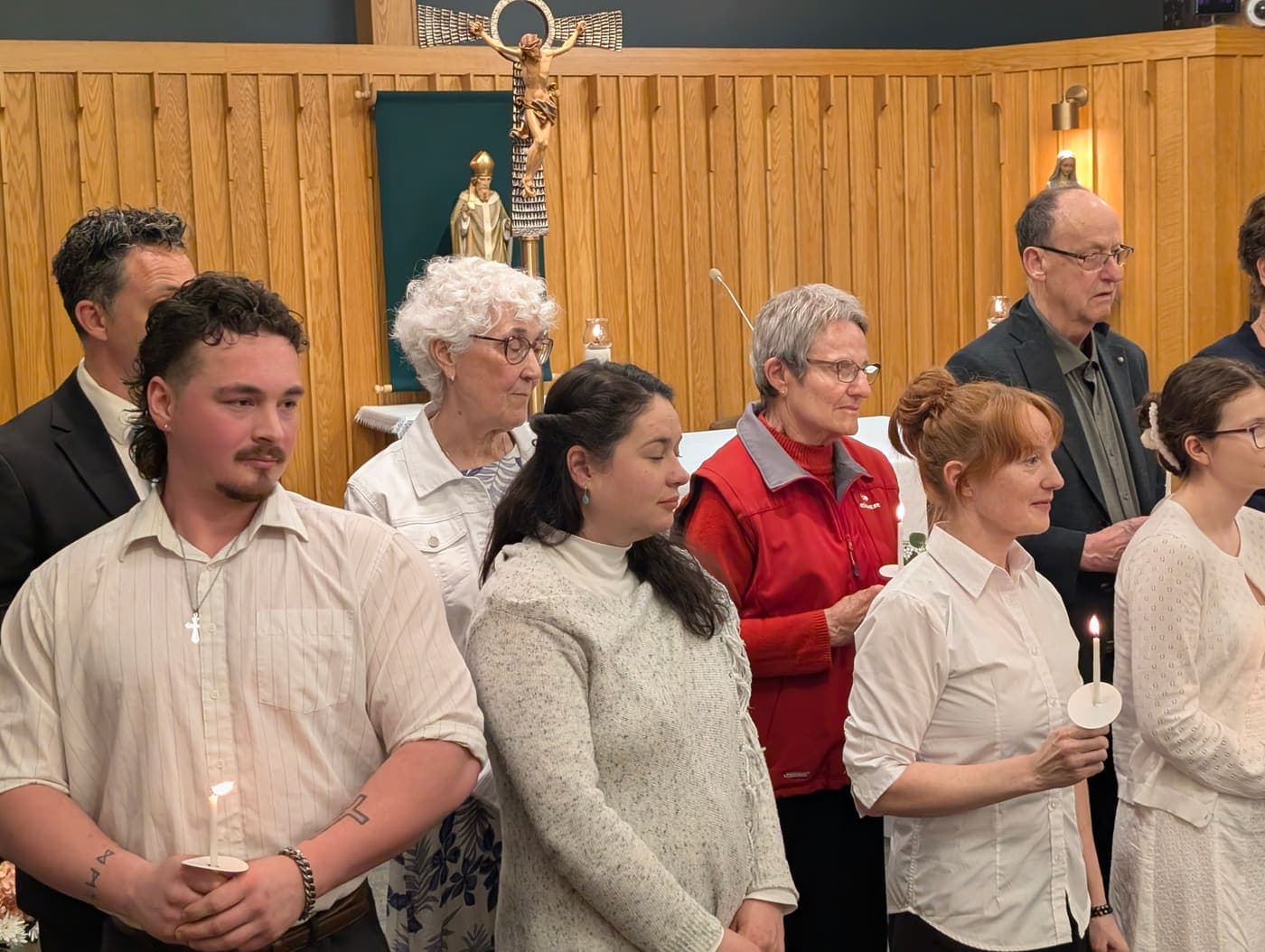 Candidates and parishioners holding lit candles during the Easter Vigil